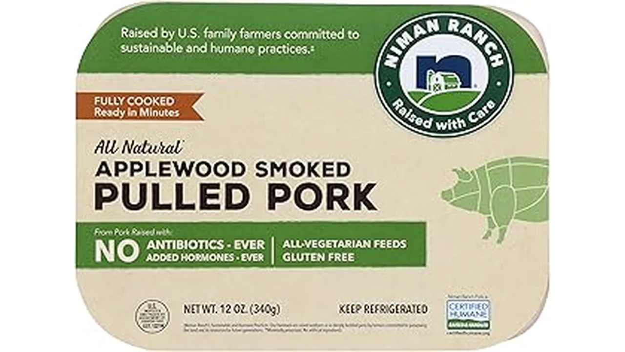 The image shows a perfectly roasted pork tenderloin with herbs, ready for serving.