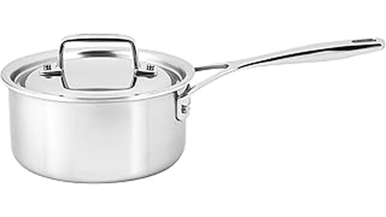 The image shows a collection of shiny stainless steel pots and pans, part of Best 31 cookware.